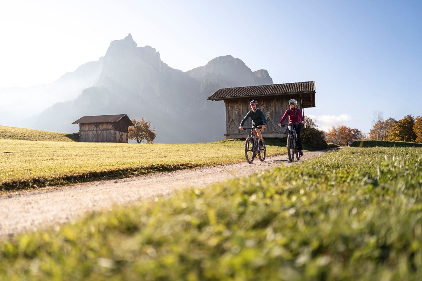Zwei Mountainbiker auf einem Feldweg vor dem Schlern